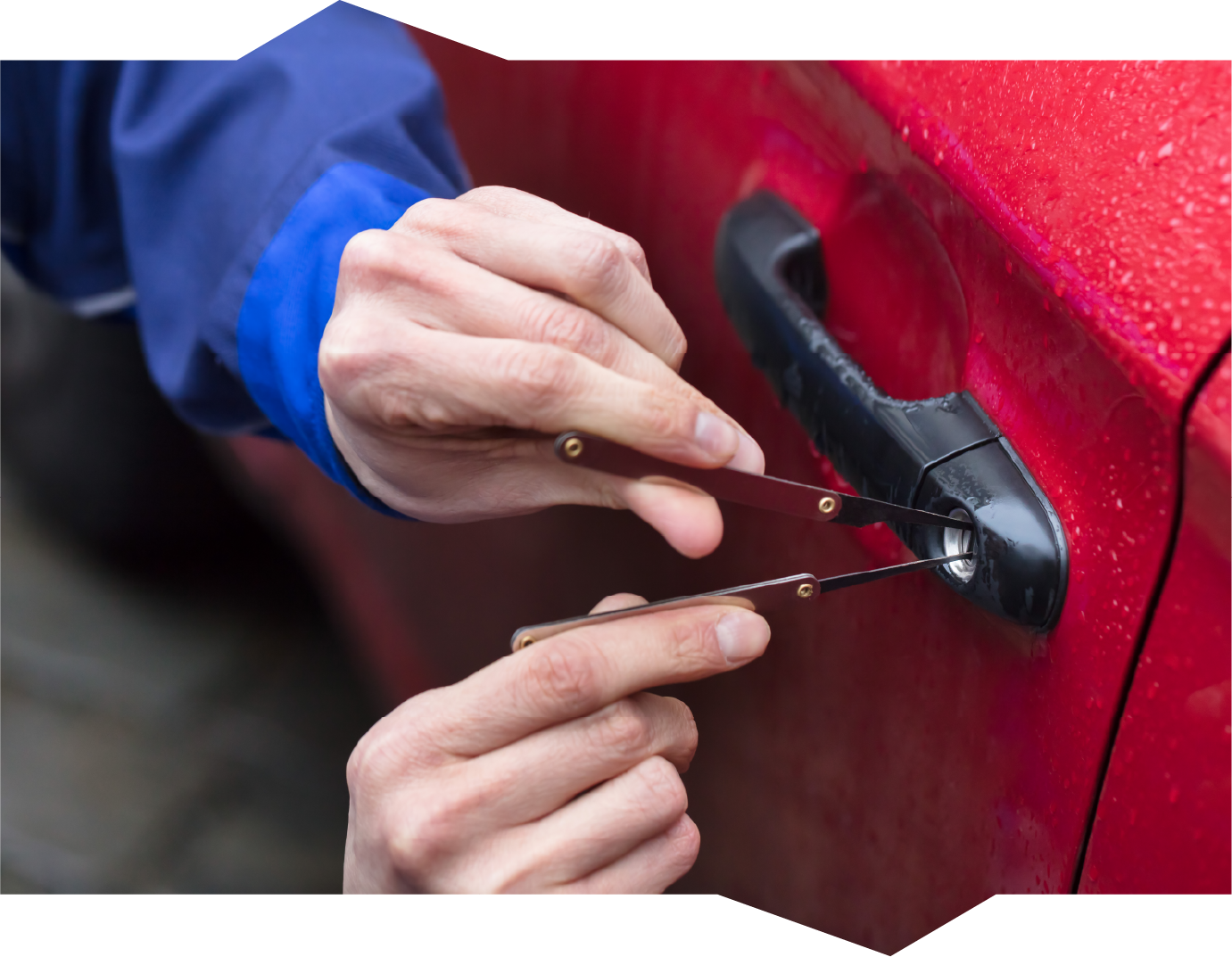 A person is trying to open a car door with a key.