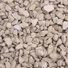 Close-up of a pile of light-colored, irregular gravel stones.