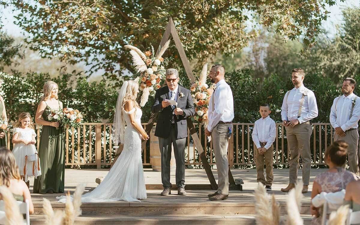 A bride and groom are getting married at a wedding ceremony.