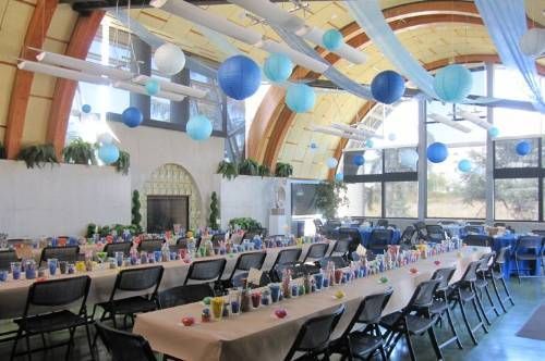 A large room with tables and chairs set up for a party