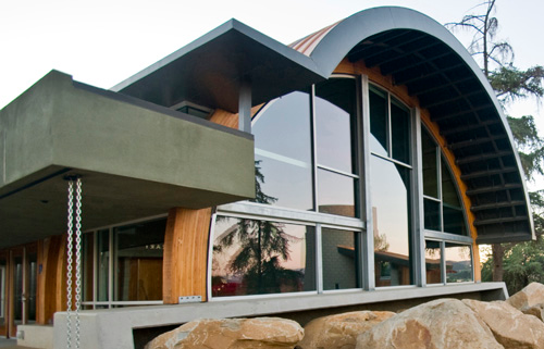 A house with a curved roof and a lot of windows