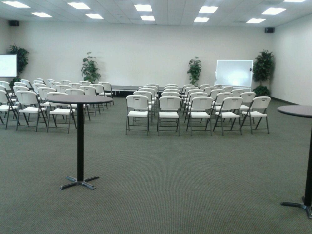 A large room with rows of chairs and tables