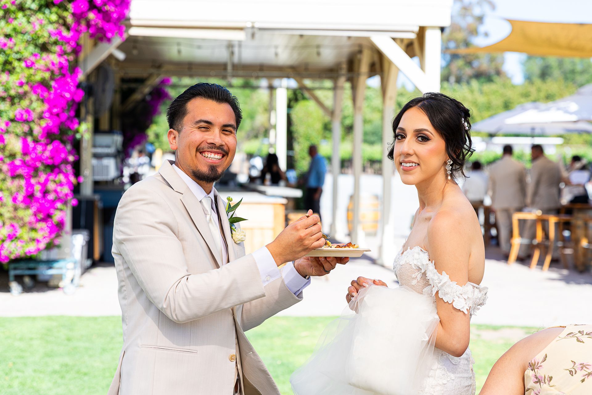 bride and groom enjoying reception food outdoor venue