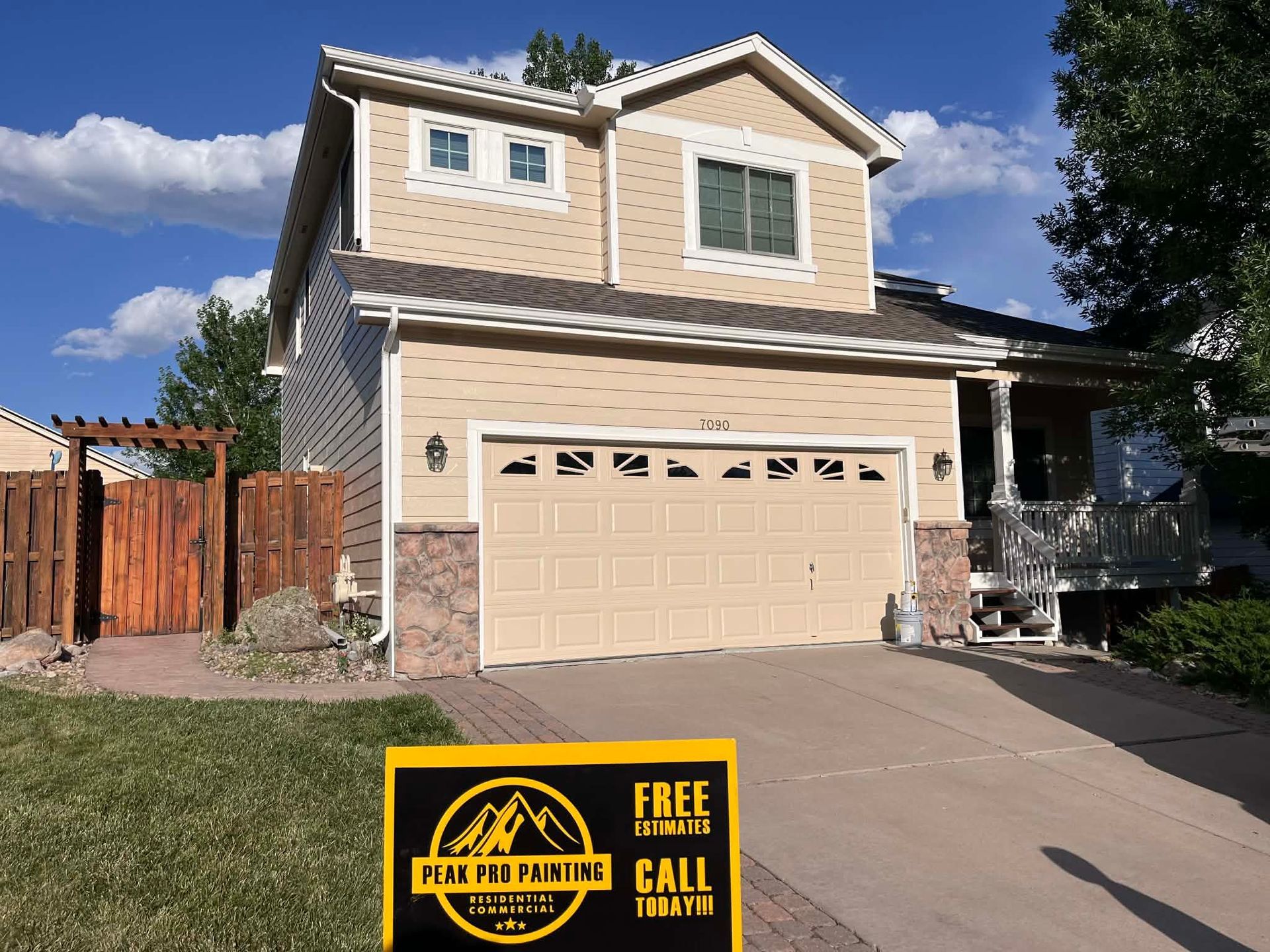 Tan two-story house with a garage and a 