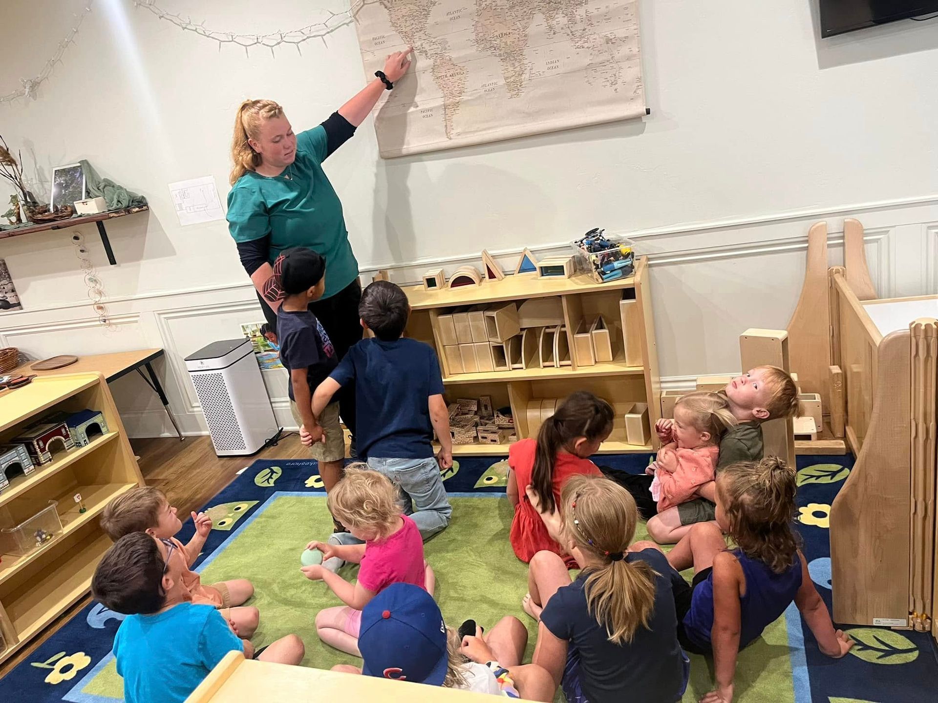 A teacher is teaching a group of children in a classroom.