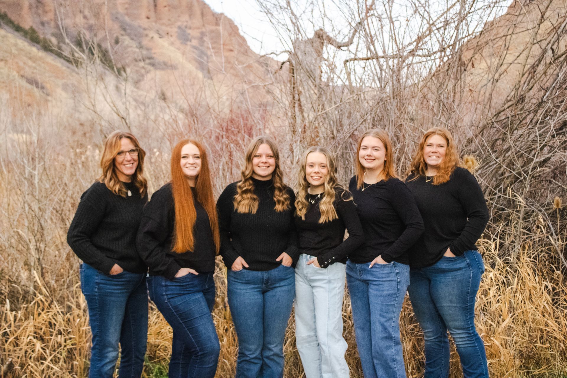 Children seated at a table, crafting. Brightly lit room with decorative items and wooden furniture.
