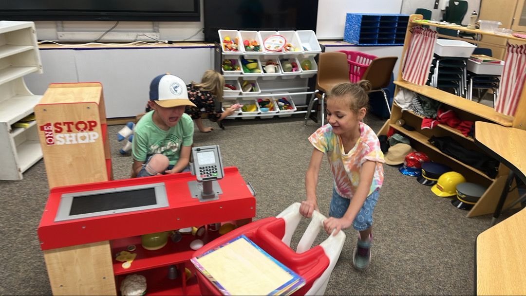 A boy and a girl are playing in a toy store.