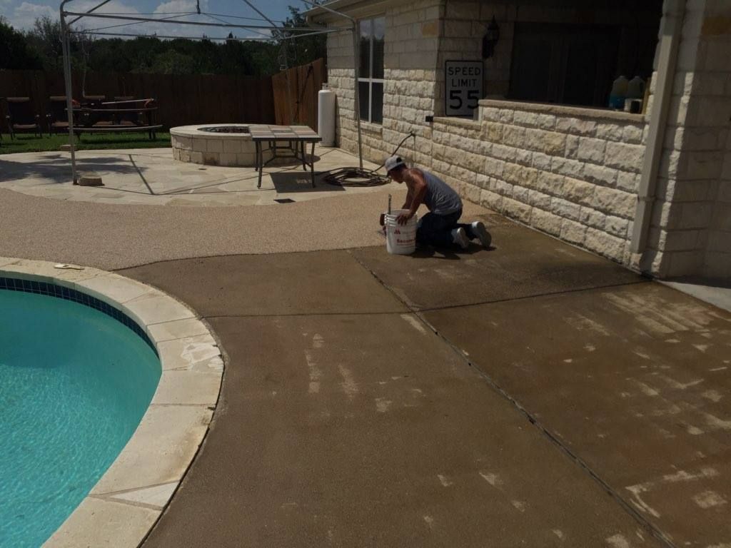 Two men are loading boxes into a van.