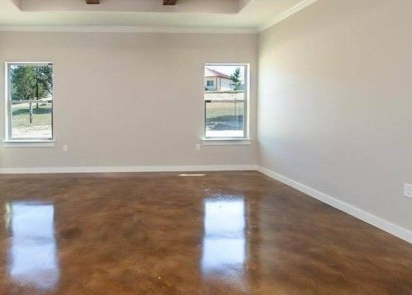 A row of semi trucks are driving down a road