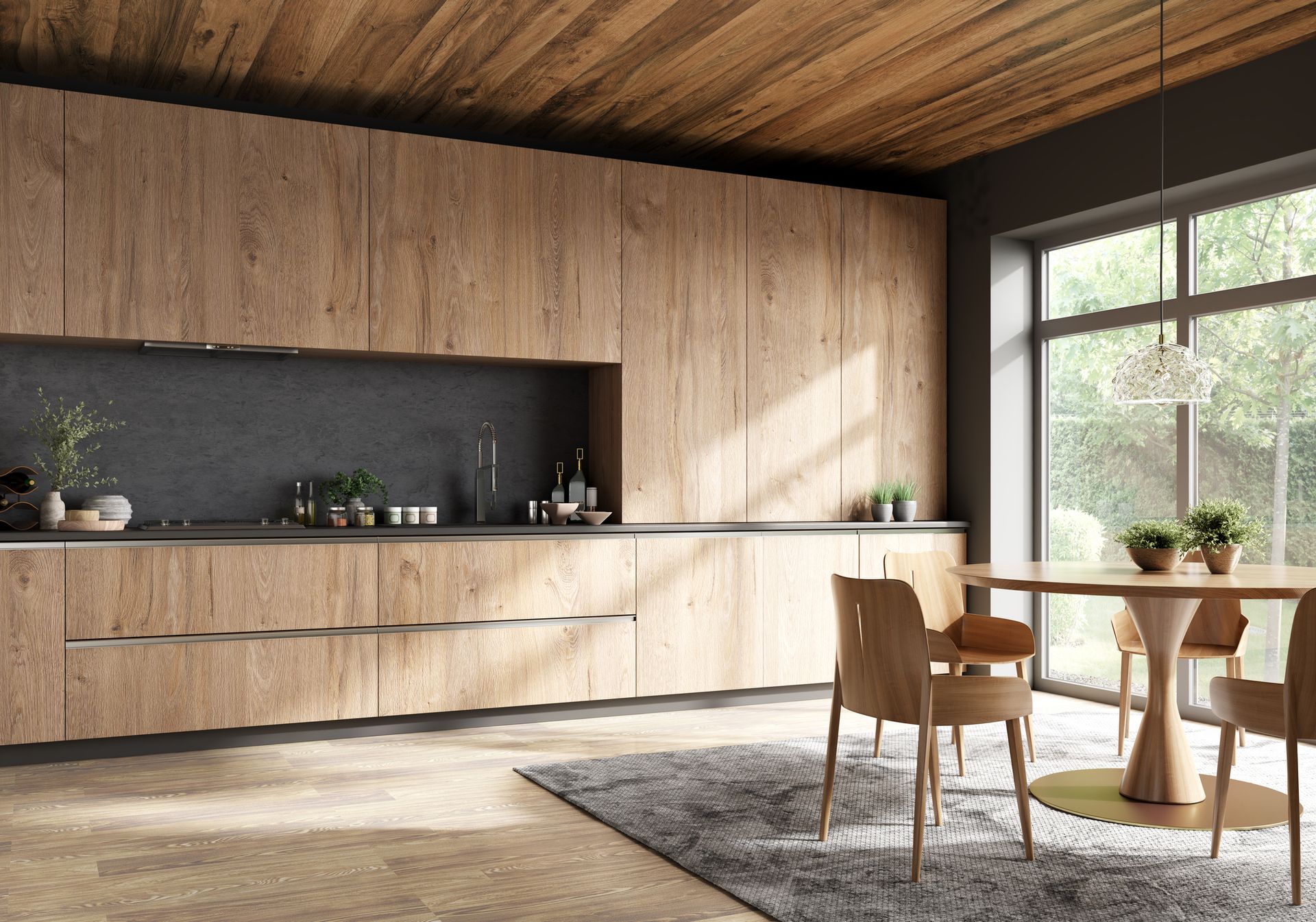 Modern kitchen with wood cabinets and ceiling, a dark countertop, dining table, and large window overlooking greenery.