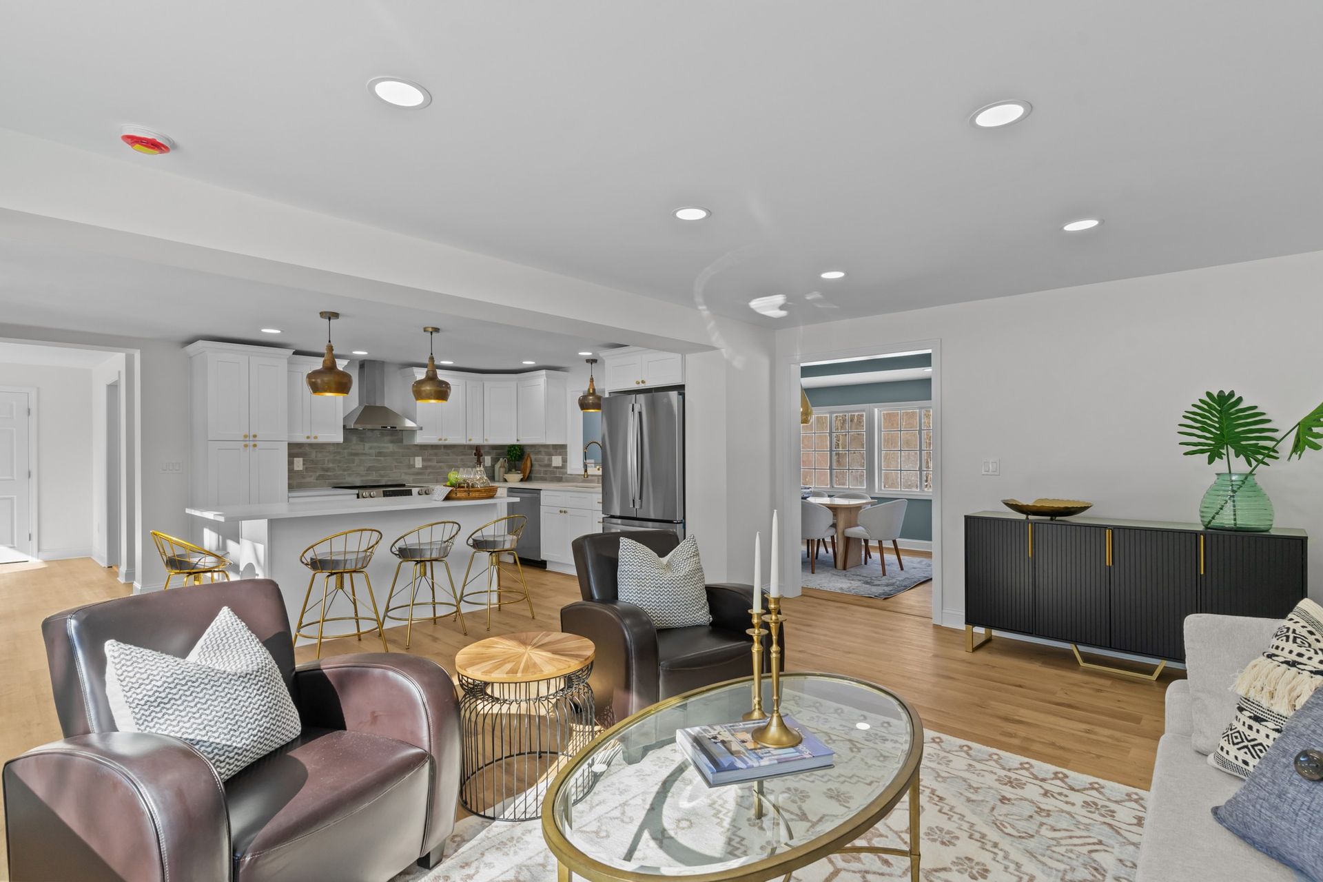 An empty living room with hardwood floors and a ceiling fan