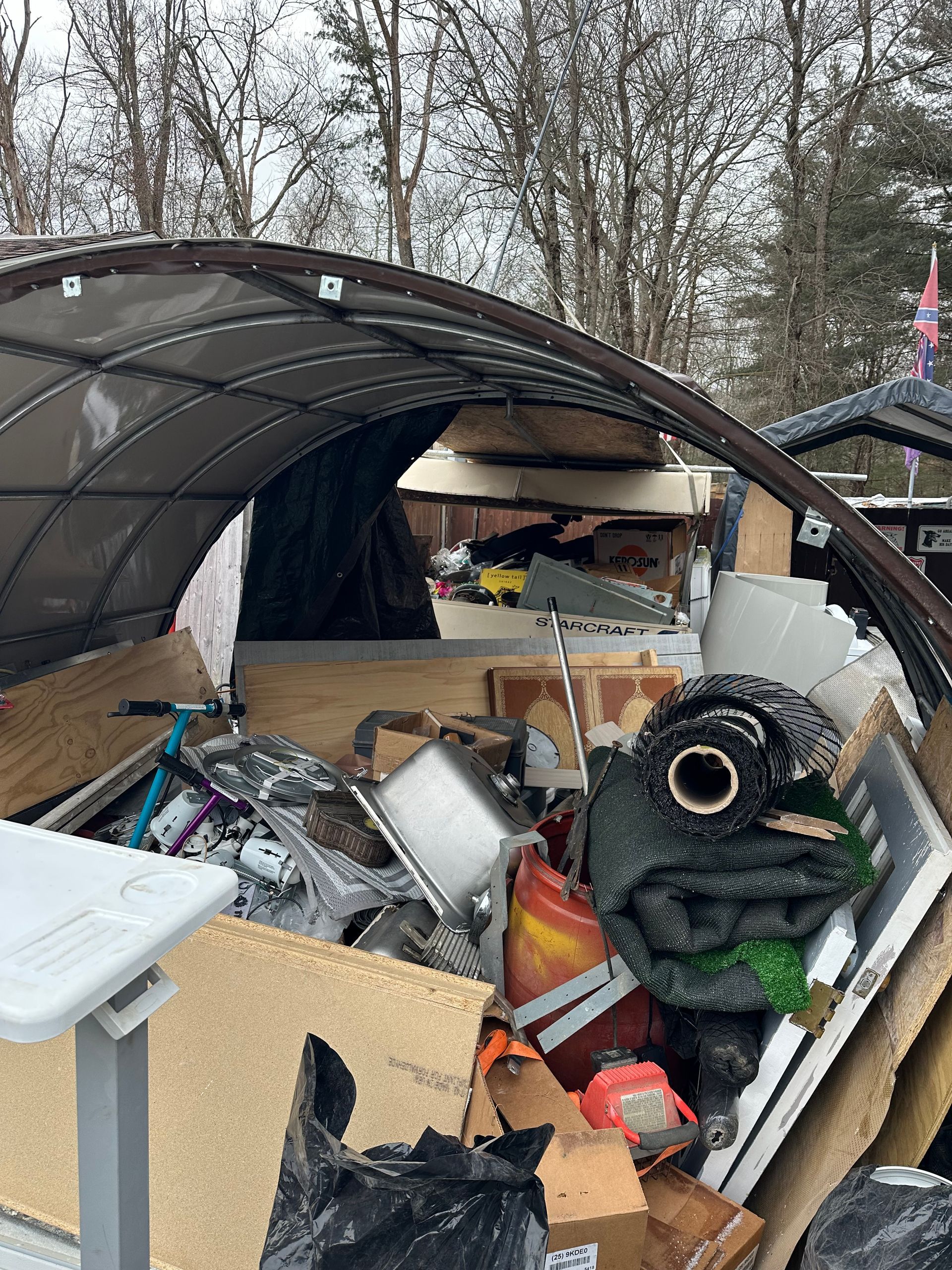 US Capitol Building framed by bare trees, sunny day.