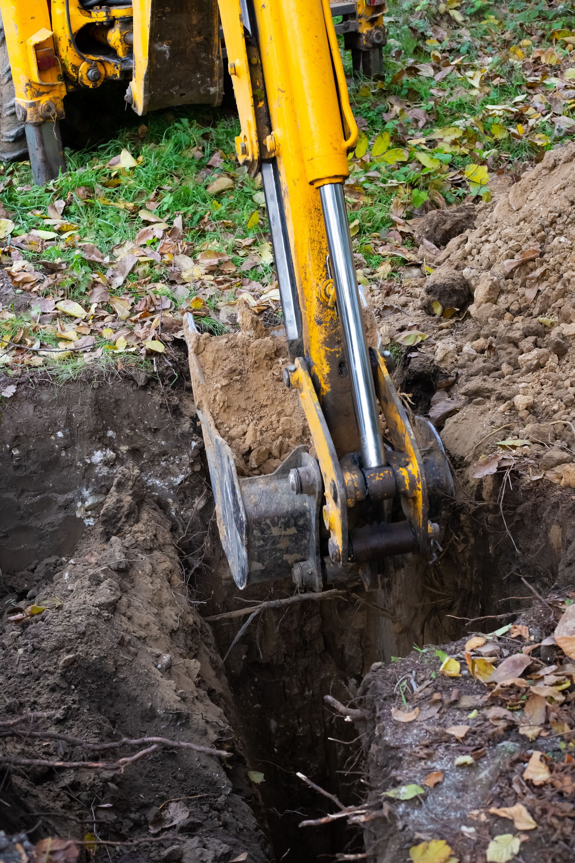 a yellow bulldozer is driving through a dirt field