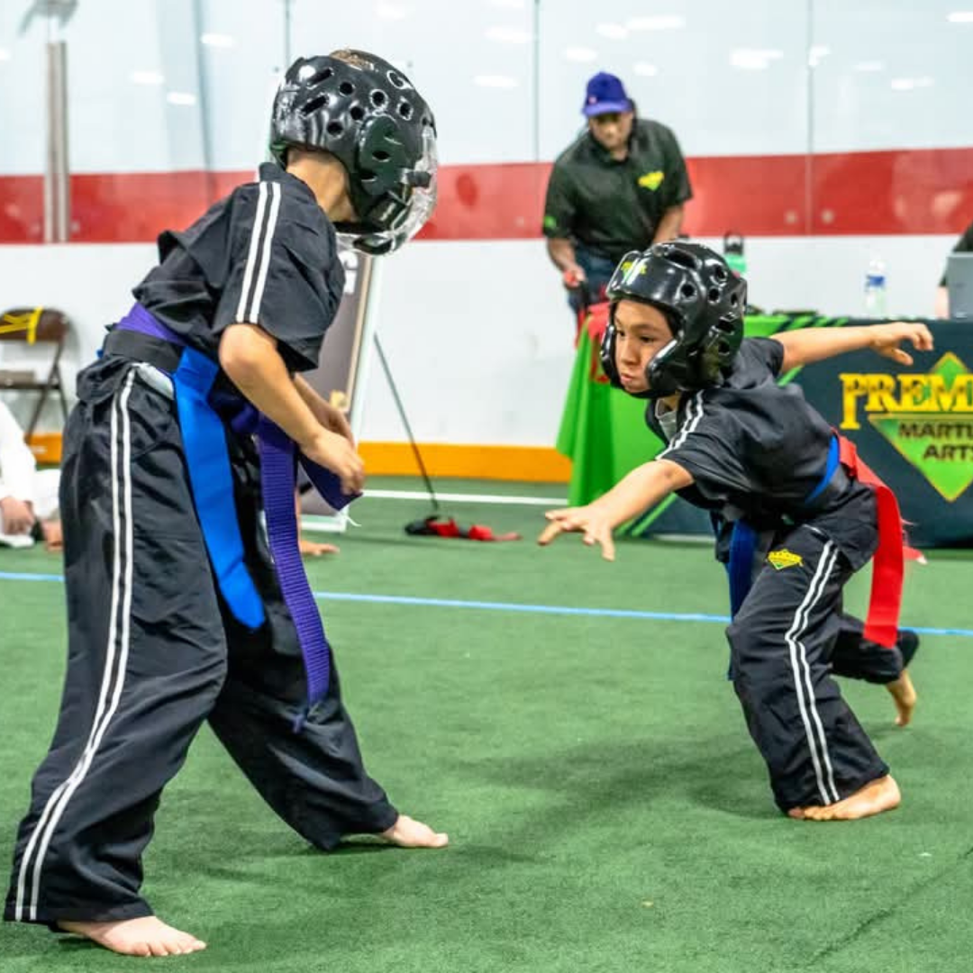 A boy and a girl are practicing taekwondo together.