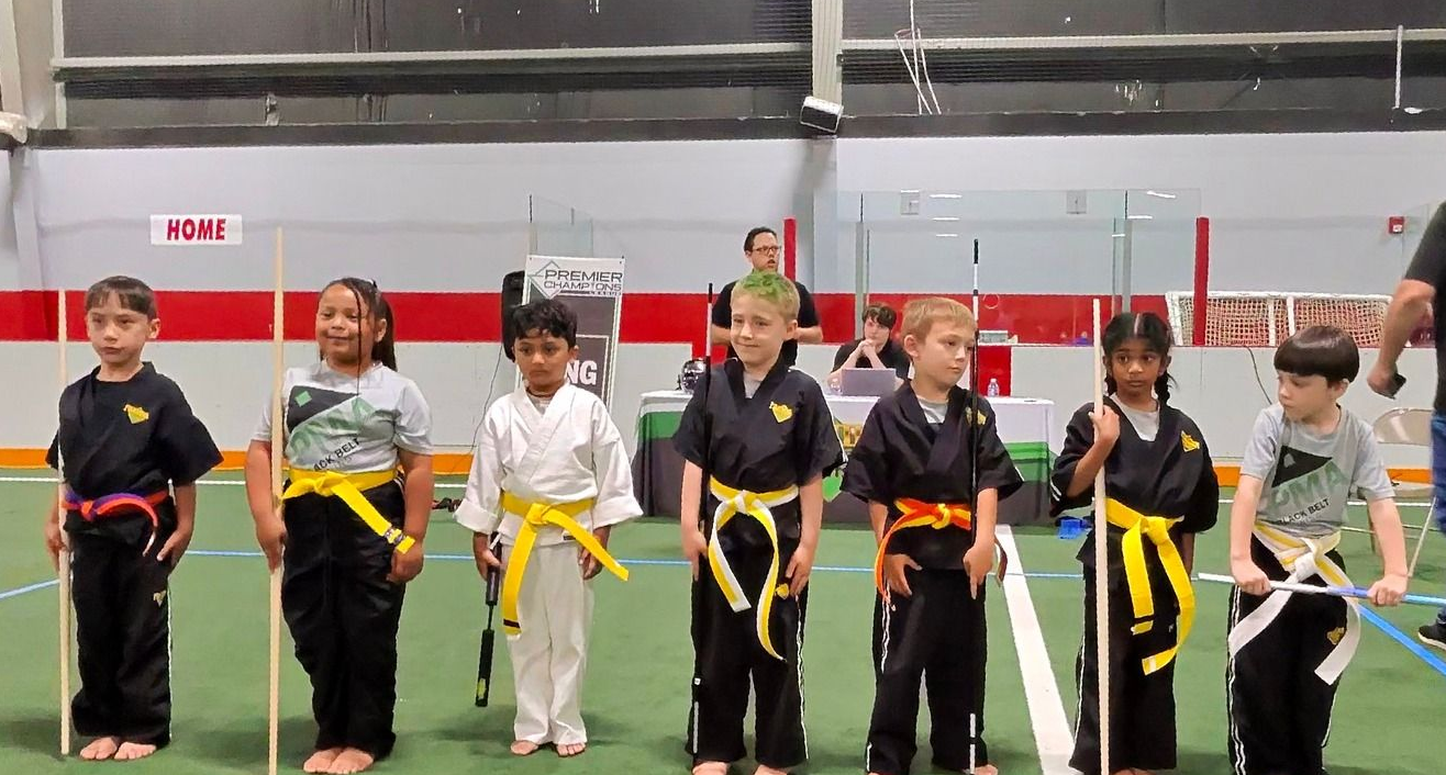 A person is holding a sparkler in their hand in the dark.