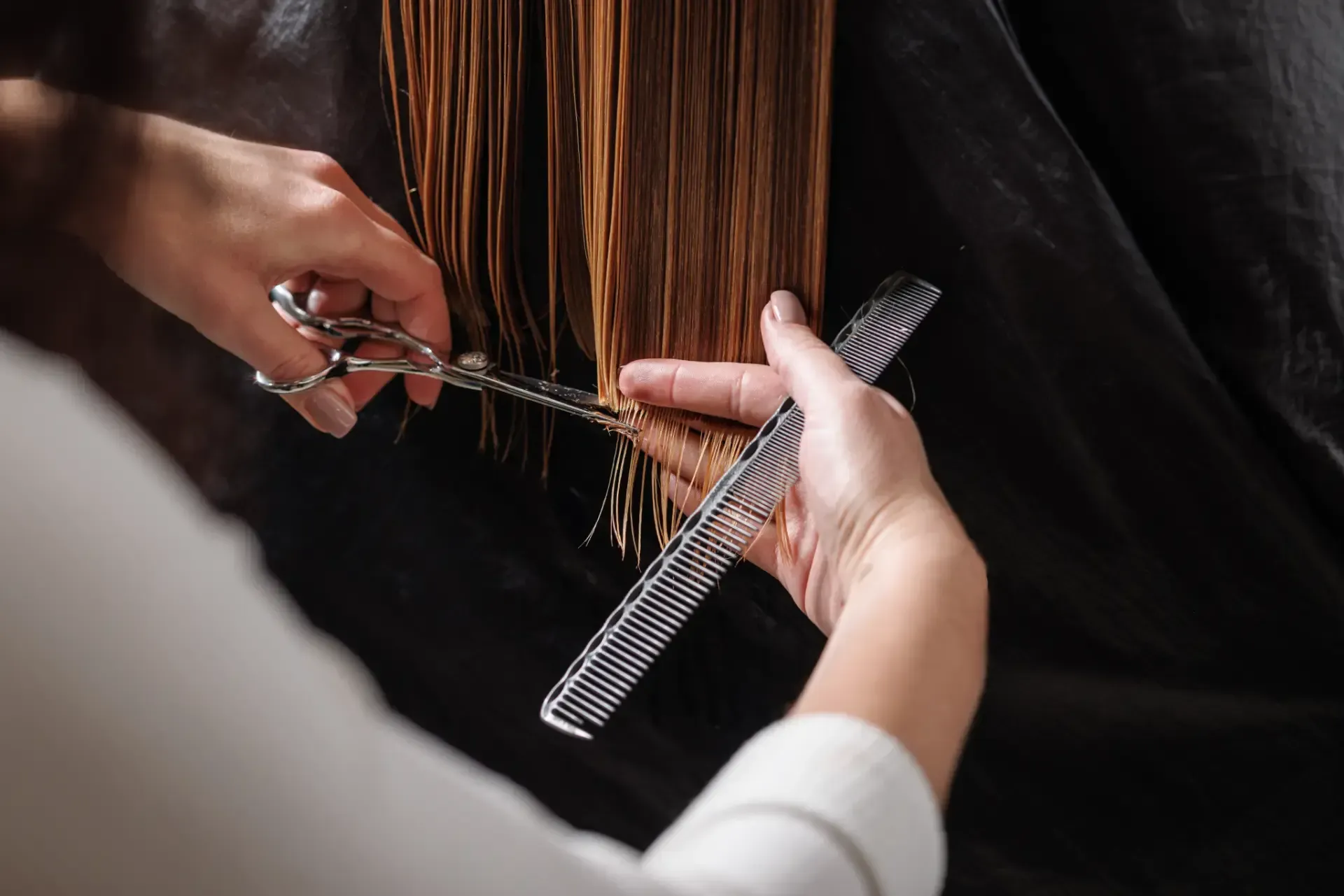 Indigo Rye | A woman is getting her hair done by a hairdresser.