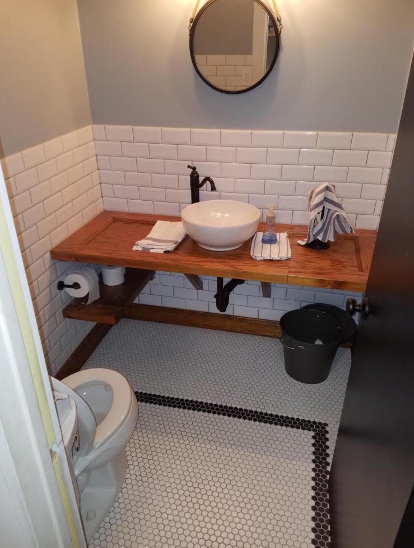 A bathroom with a sink , toilet and mirror