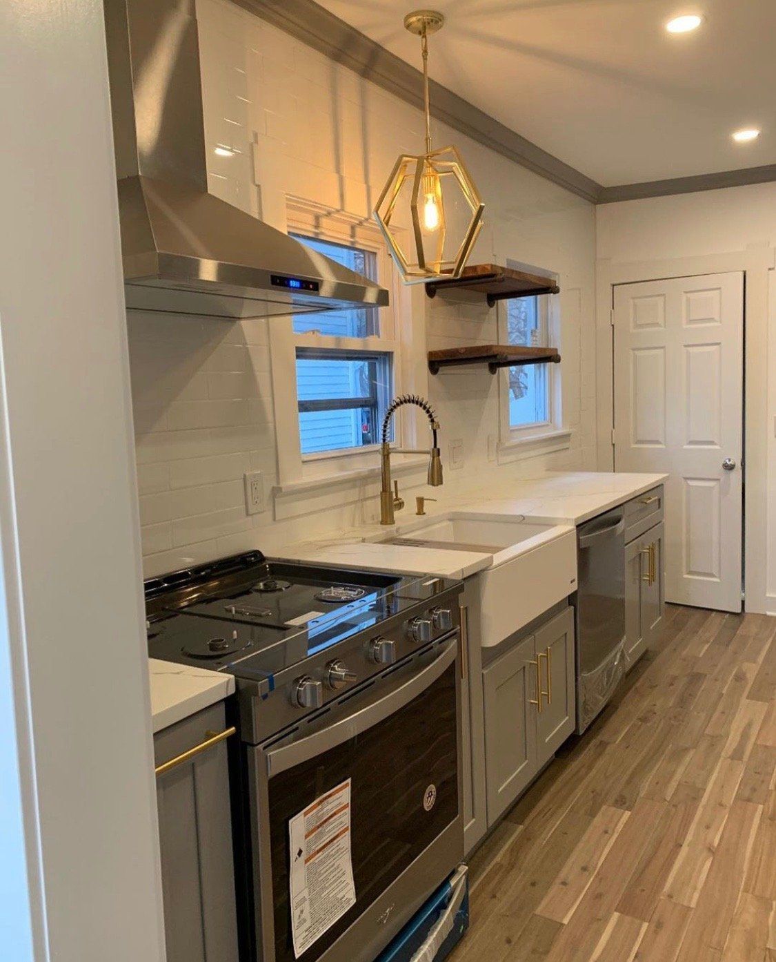 A kitchen with a stove , sink , and dishwasher