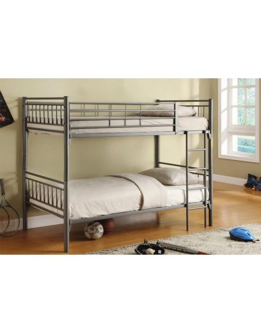 A bunk bed is sitting in a room next to a window.