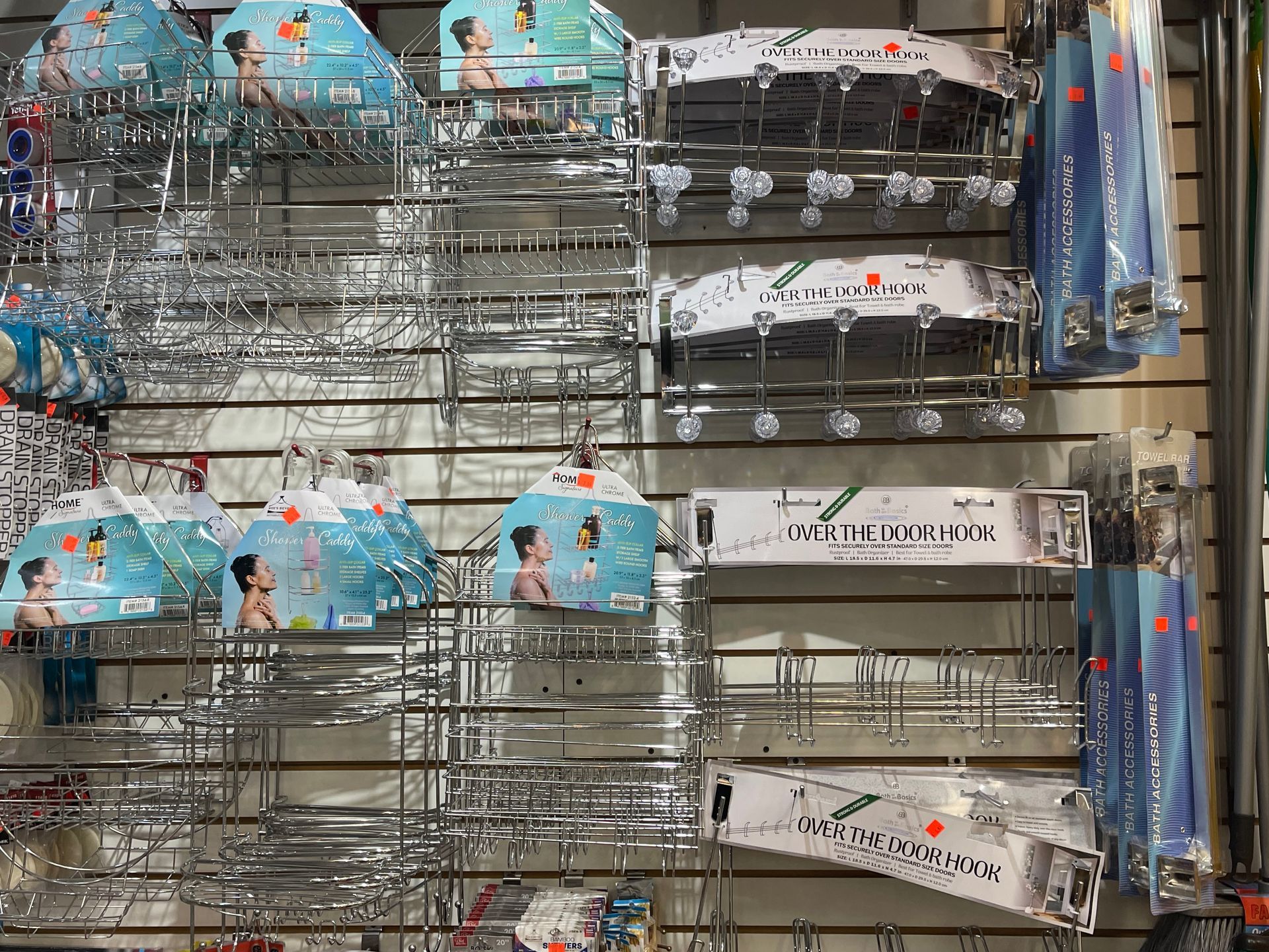 A bunch of umbrellas are hanging on a wall in a store.