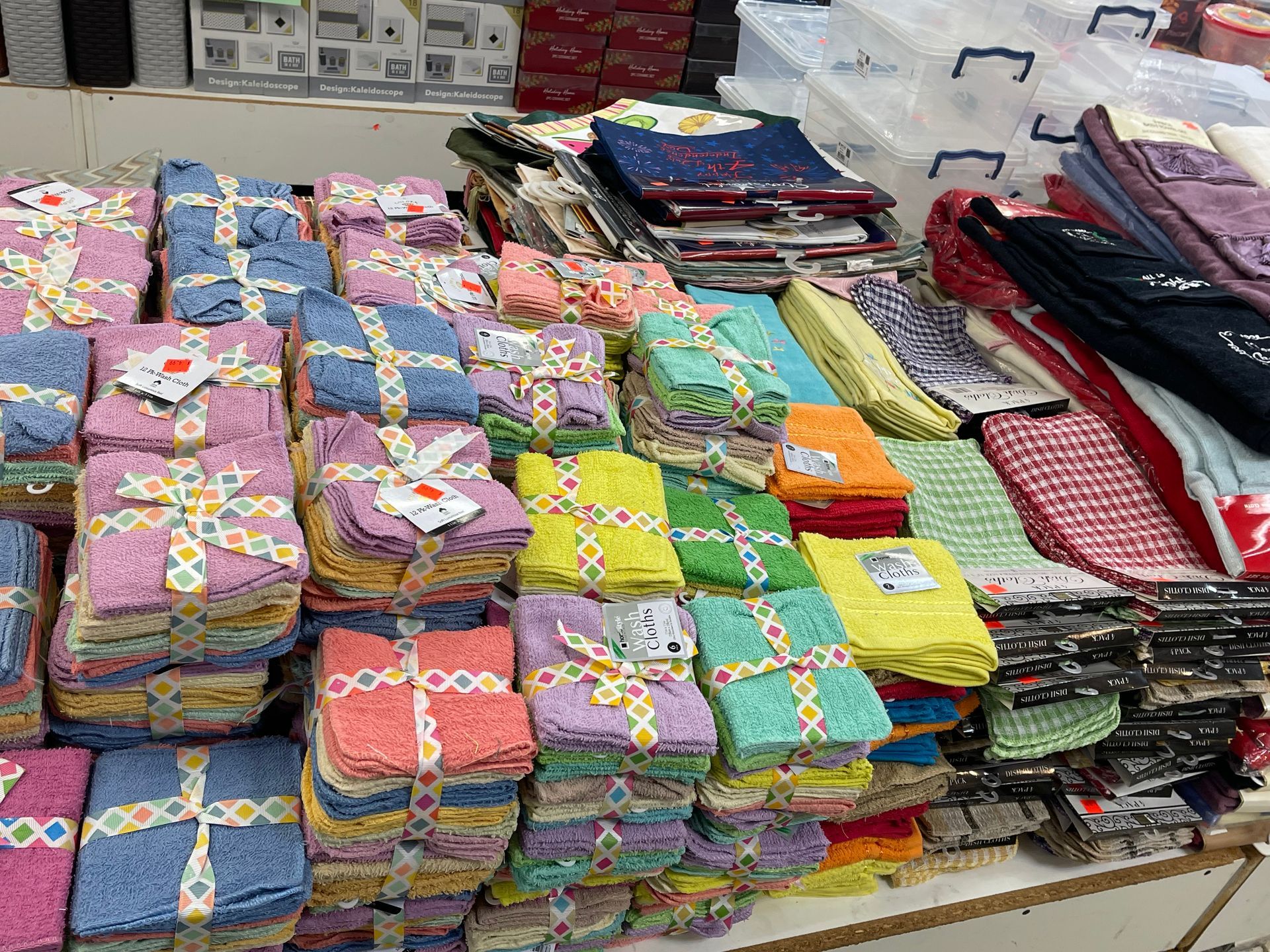 A bunch of towels are stacked on top of each other on a table.
