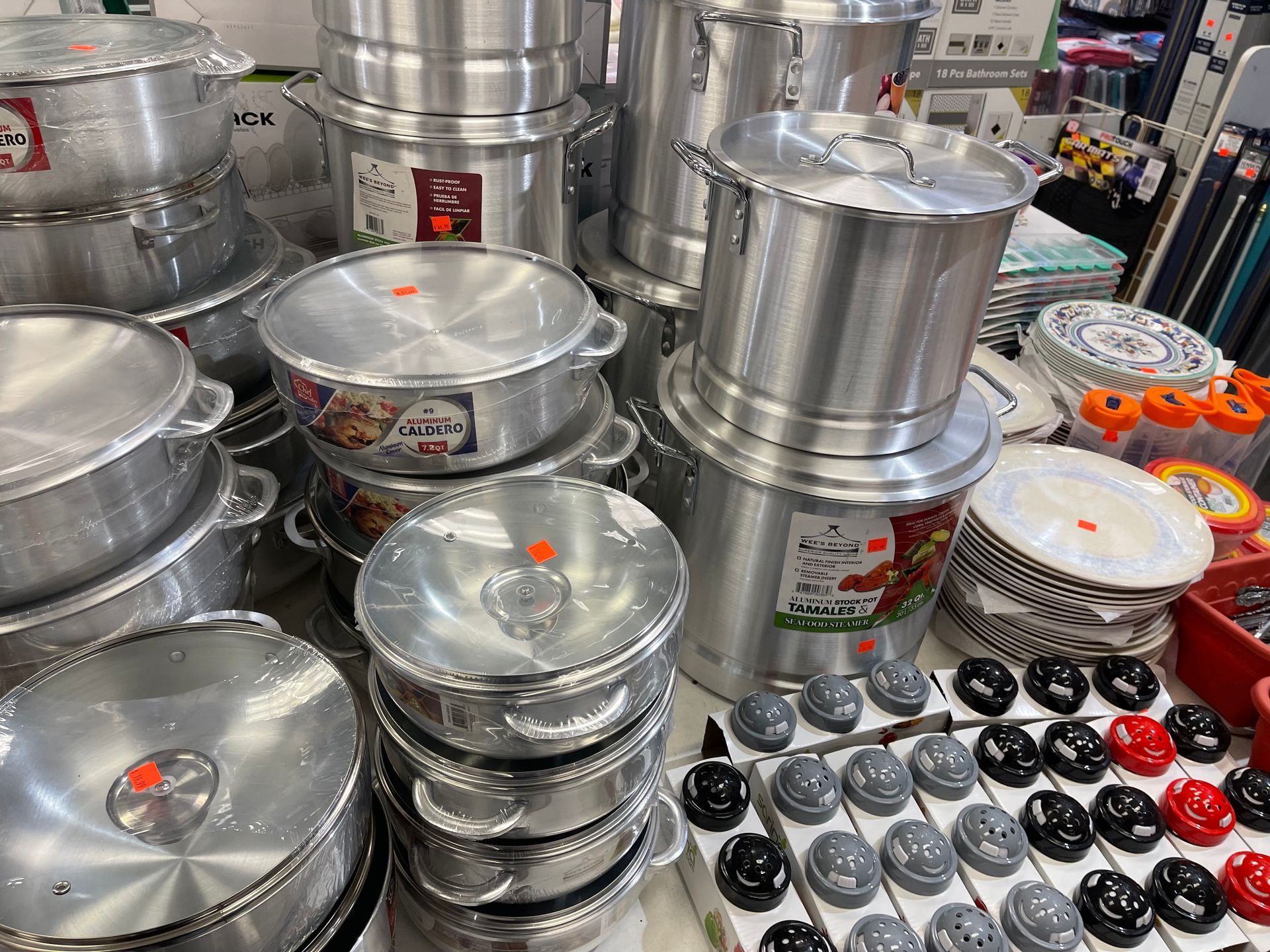 A bunch of pots and pans are stacked on top of each other on a table.