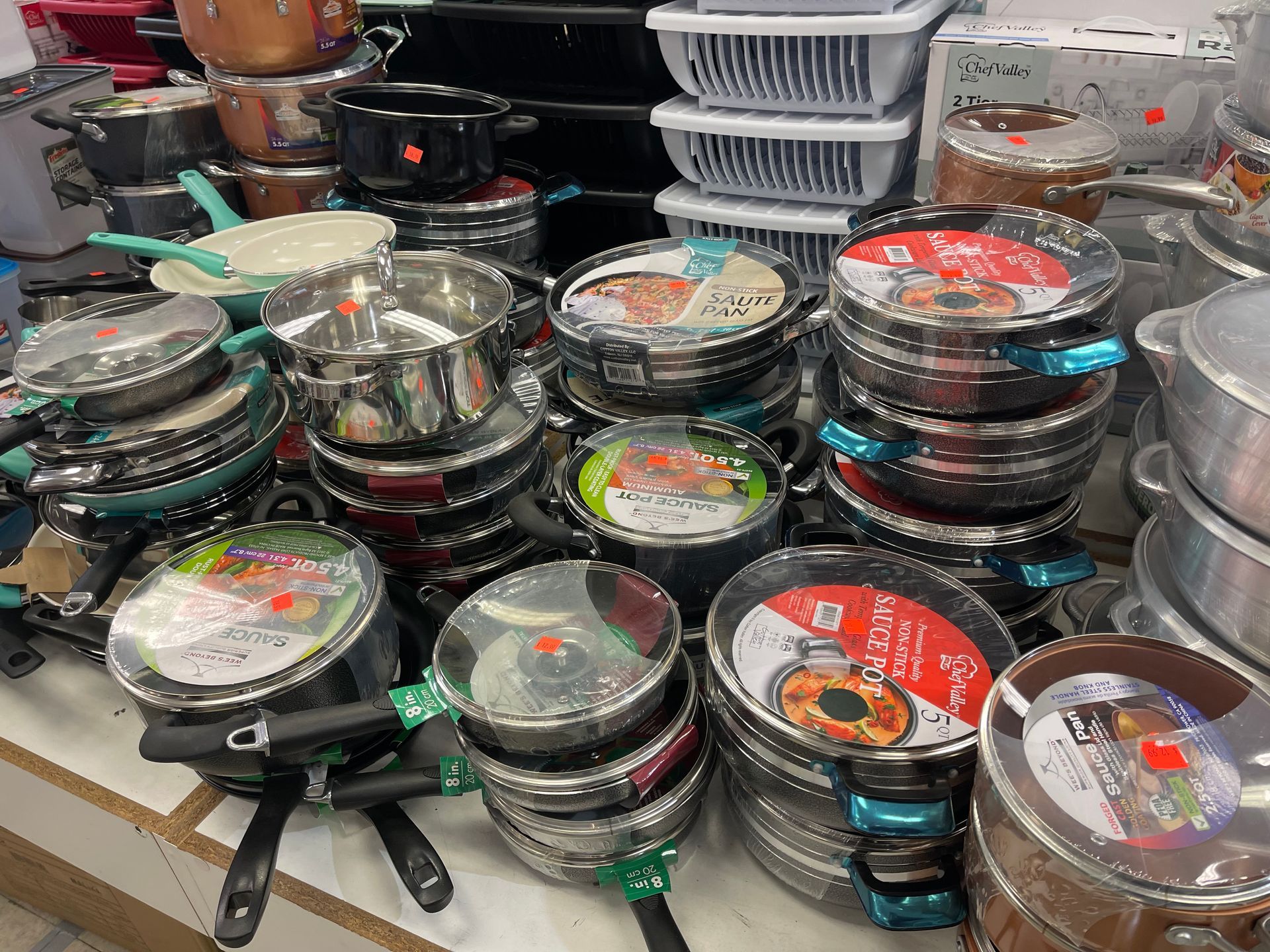 A bunch of pots and pans are stacked on top of each other on a table.