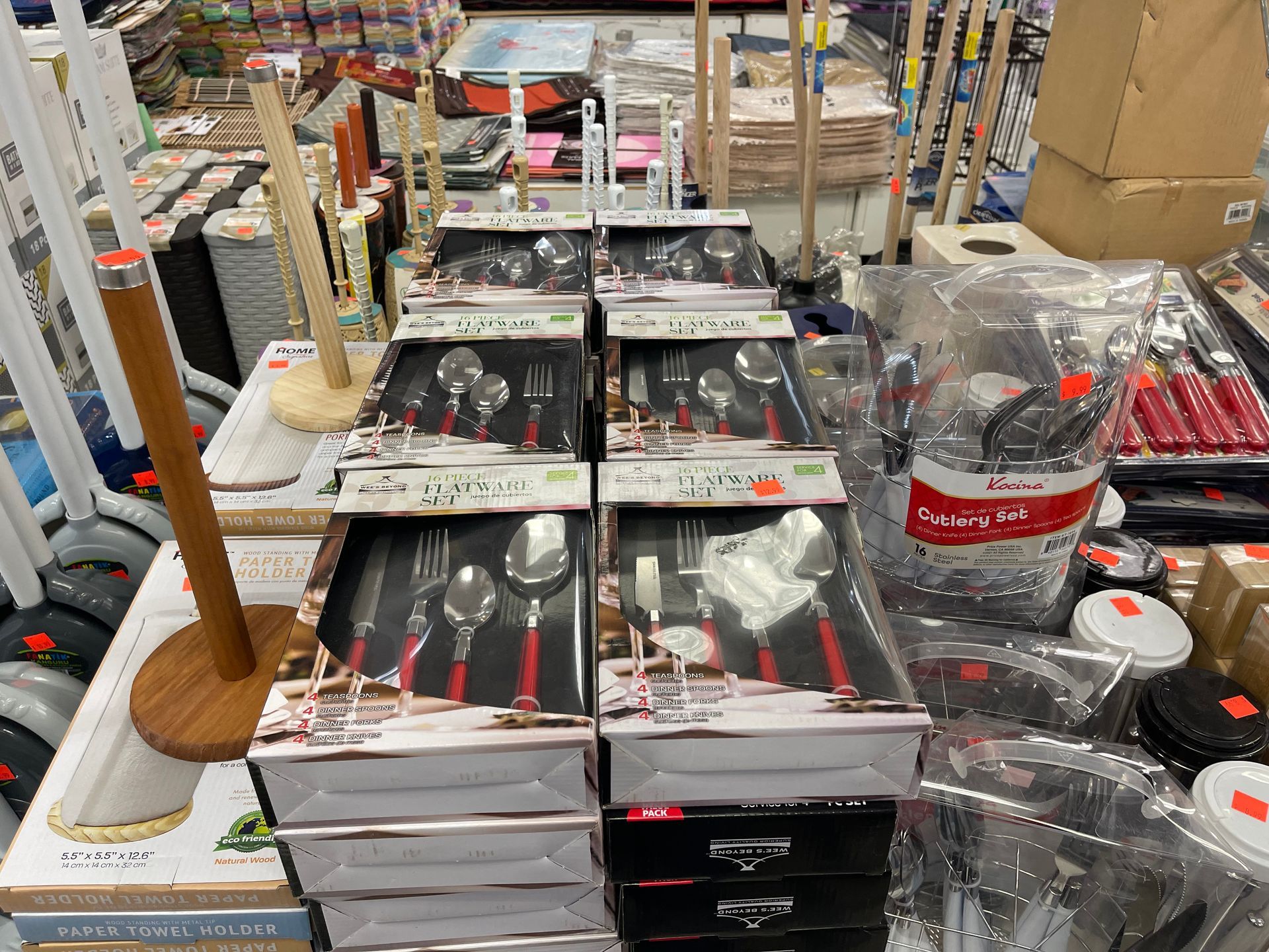 A bunch of silverware is stacked on top of each other in a store.