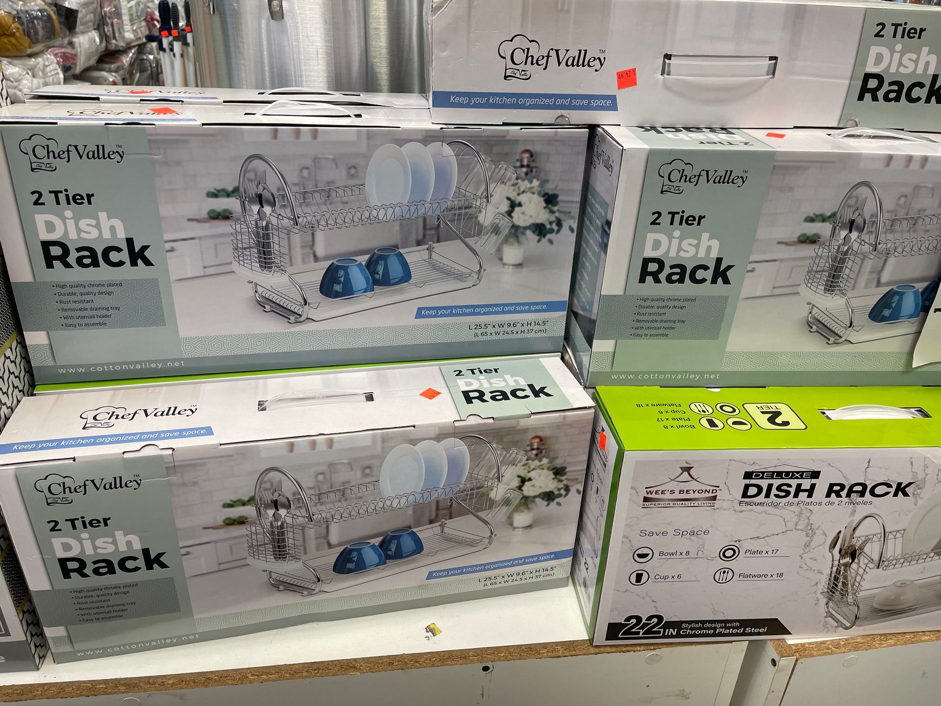 Boxes of dish racks are stacked on top of each other on a shelf.