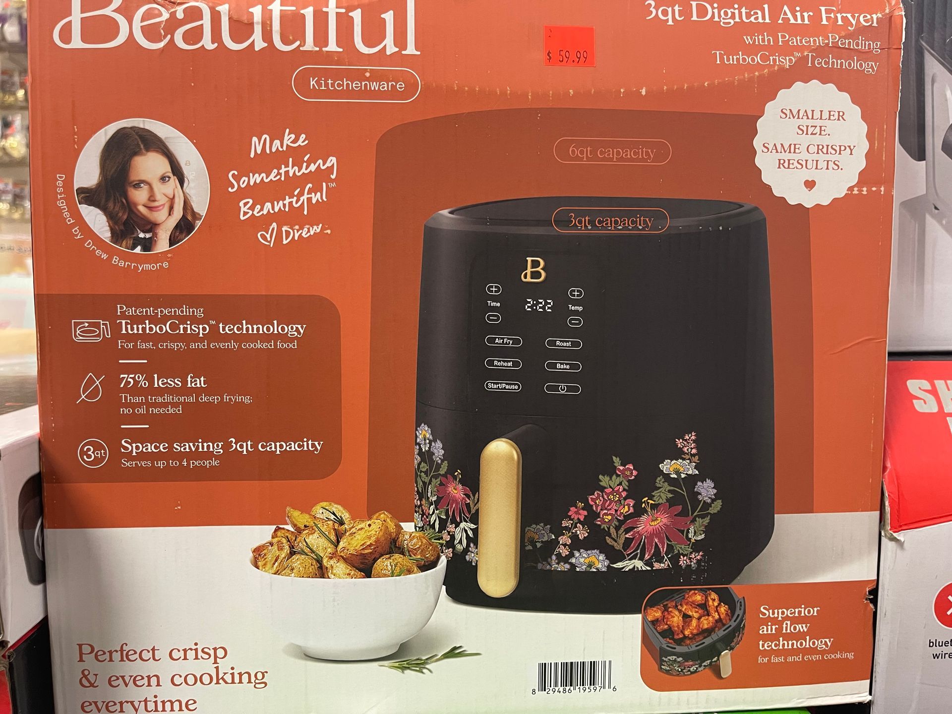 A beautiful air fryer is sitting on a shelf in a store.