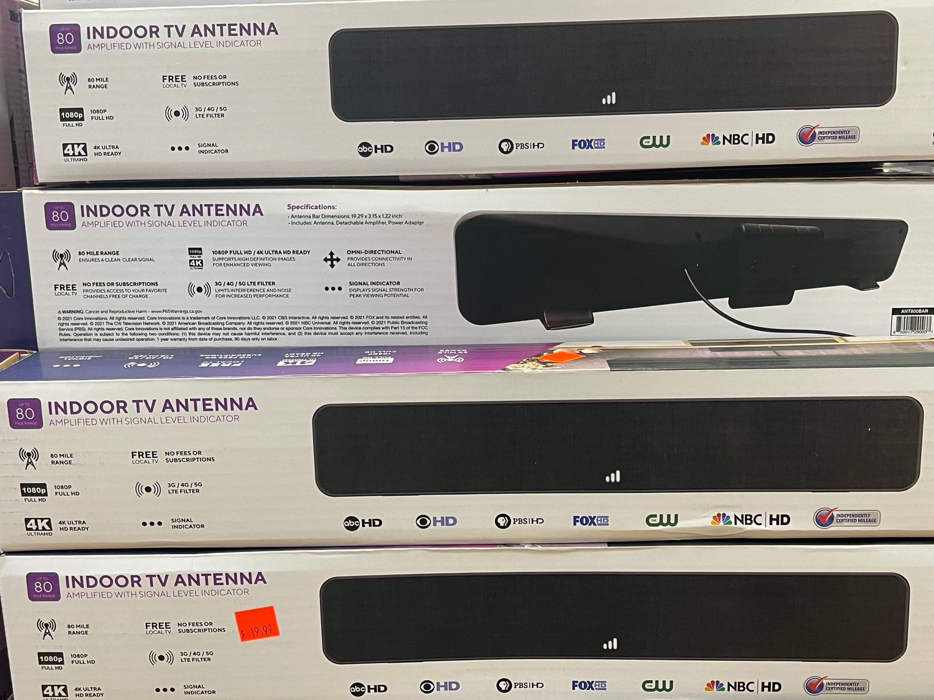 Several boxes of indoor tv antennas are stacked on top of each other