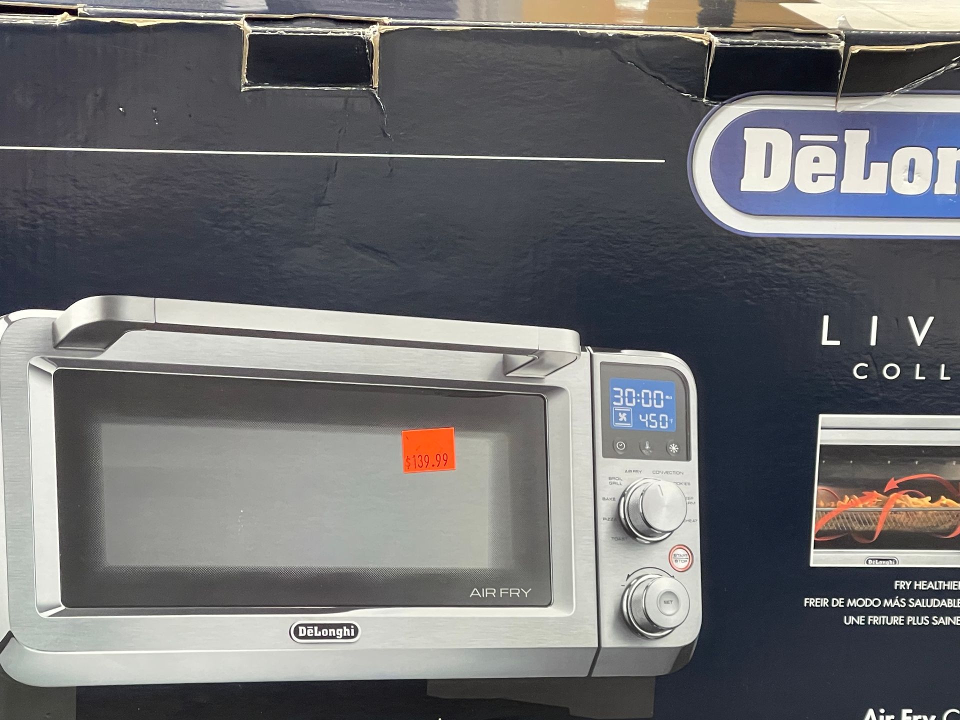 A delonghi oven is sitting in a box