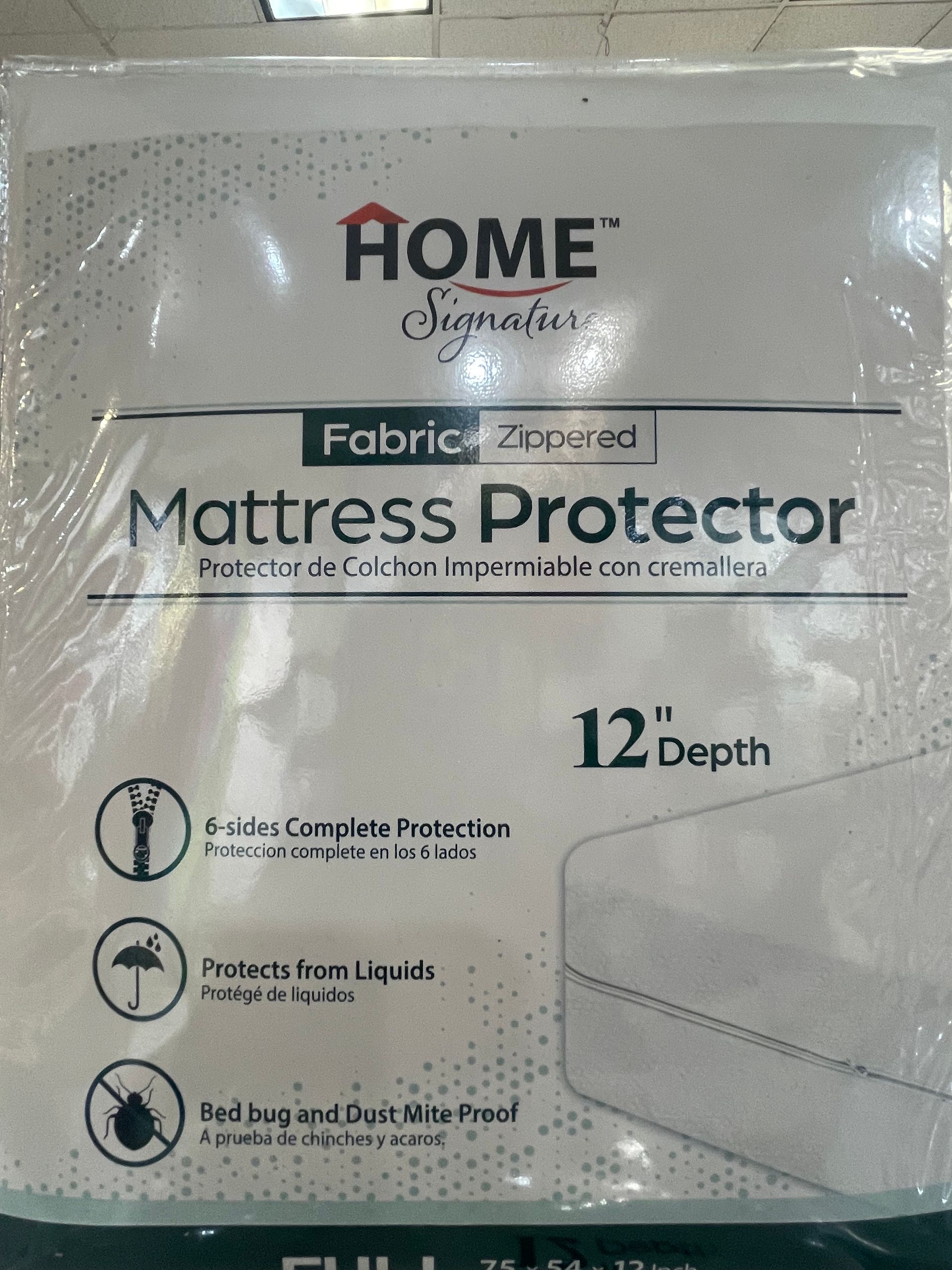 A white mattress protector is in a plastic bag.