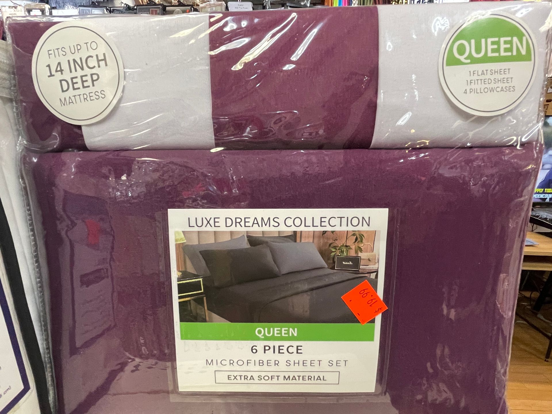 A queen size bedspread is sitting on top of a bed in a store.