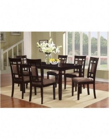 A dining room table and chairs with a vase of flowers on it