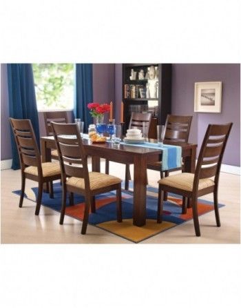 A dining room with a table and chairs and purple walls