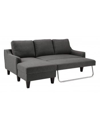 A grey sectional couch with a chaise lounge that can be converted into a bed.