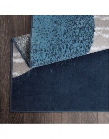 A blue rug is laying on a wooden floor.