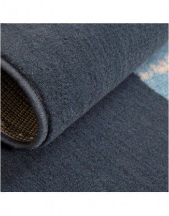 A close up of a blue rug with a pattern on it.