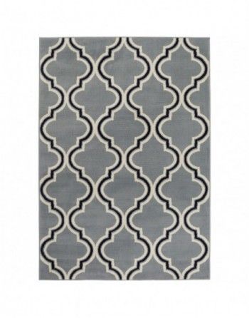 A grey rug with a black and white pattern on it