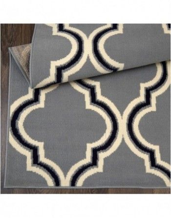 A gray rug with a black and white pattern on it