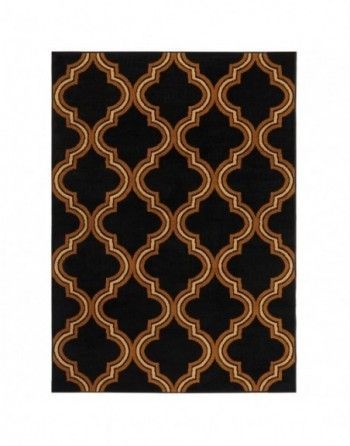 A black and gold rug with a geometric pattern