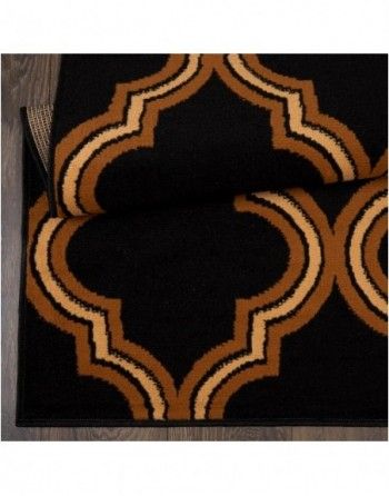 A black and brown rug with a geometric pattern on it