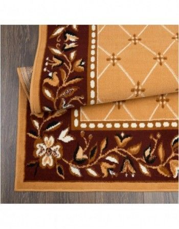 A rug with a floral design on it is sitting on a wooden floor.