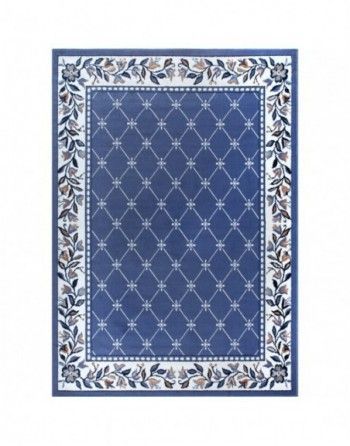 A blue rug with a floral border on a white background