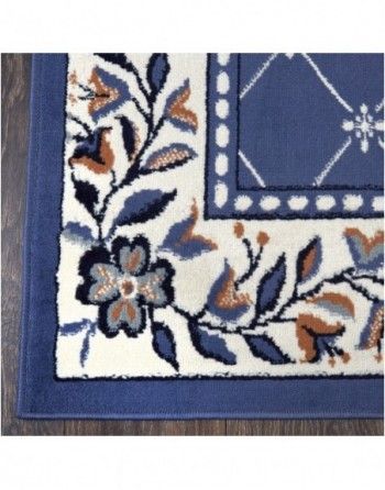 A blue and white rug with flowers and leaves on it