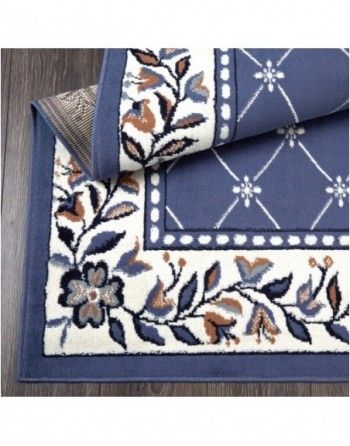 A blue rug with flowers and leaves on it