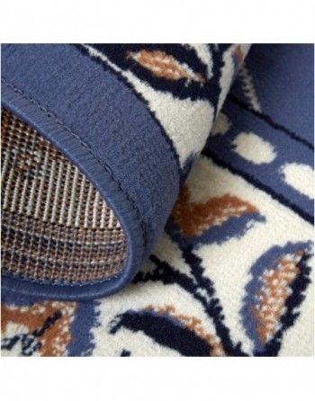 A blue and white rug with leaves on it