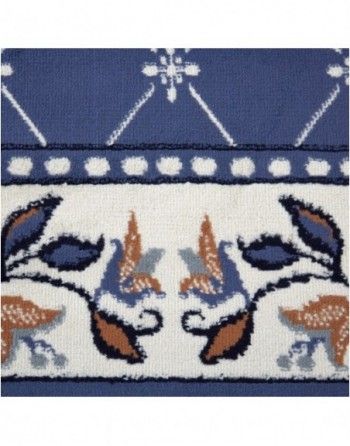 A blue and white rug with a floral pattern on it