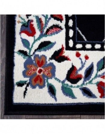 A black and white rug with flowers and leaves on it